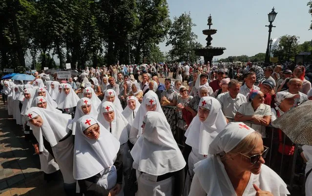 Ukrainian Orthodox nuns attend a prayer service held at the St. Vladimir's Hill in downtown Kiev, Ukraine, 27 July 2021. Orthodox believers mark the 1033rd anniversary of the Kievan Rus Christianization on 27 and 28 July 2021. (Photo by Sergey Dolzhenko/EPA/EFE)