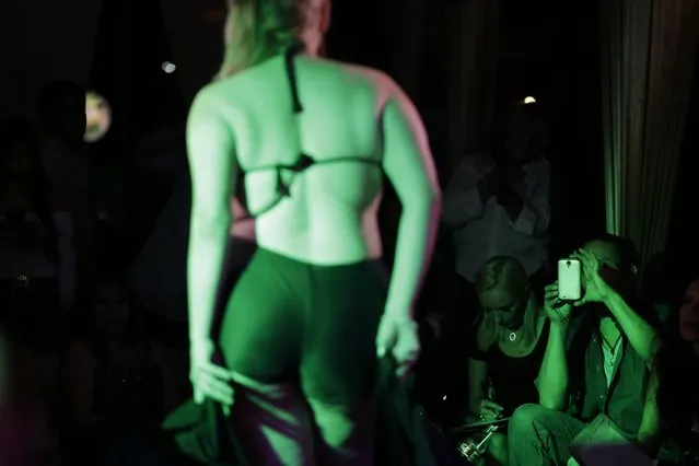 A judge makes a picture of contestant Emilia Martinez as she competes in the swimsuit portion of the fourth annual “Miss Gordita” beauty contest in Asuncion, Paraguay, Saturday, April 25, 2015. Contestants and organizers see the pageant as a way to fight discrimination against overweight and obese people in general, and women in particular. (Photo by Jorge Saenz/AP Photo)