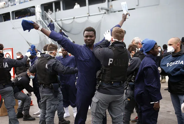 Migrants are inspected by policemen as they disembark the German naval vessel Frankfurt Am Main in the Sicilian harbour of Pozzallo, Italy, March 16, 2016. (Photo by Antonio Parrinello/Reuters)
