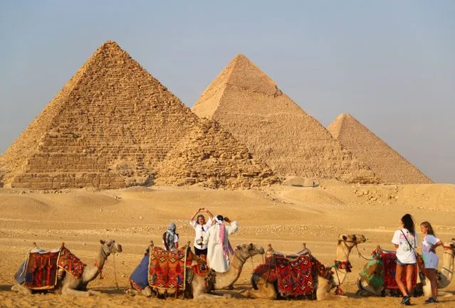 Tourists visit the Giza Pyramids in Giza, Egypt, on October 21, 2021. Egypt has entered peak tourist season as the weather is becoming cooler, and international flights to the country suspended due to COVID-19 are gradually resuming. The Giza Pyramids scenic spot is being visited by more and more tourists. (Photo by Xinhua News Agency/Rex Features/Shutterstock)