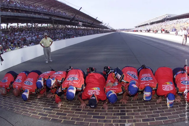 Jeff Gordon's Hendrick Motorsports team kisses the brick paving that marks the start/finish line after winning NASCAR Winston Cup Brickyard 400 at the Indianapolis Motorspeedway in Indianapolis, Indiana