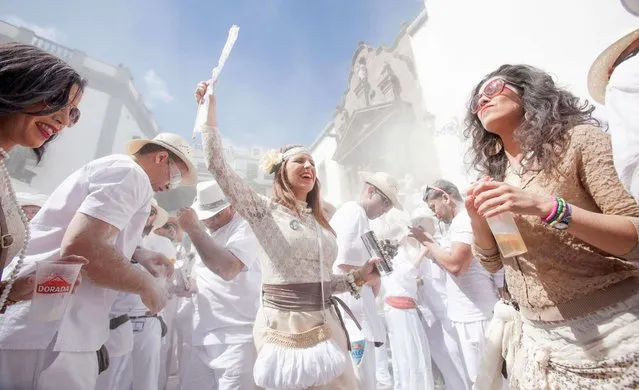 People throw talcum powder as they take part in the carnival of “Los Indianos” (the Indians) in Santa Cruz de la Palma, on the Spanish Canary island of Las Palma on March 3, 2014. (Photo by Desiree Martin/AFP Photo)