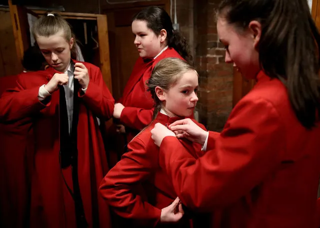 Choristers get into their robes in Lichfield Cathedral before they perform in the Christmas by Candlelight Concert, in Lichfield, Britain on December 11, 2021. (Photo by Carl Recine/Reuters)