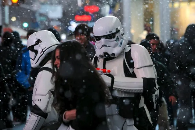 Men dressed as Storm Trooper characters from “Star Wars” walk in Times Square as snow falls down during the first day of spring in New York, March 20, 2016. (Photo by Eduardo Munoz/Reuters)