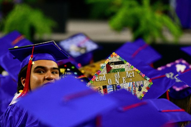 A graduate with a mortarboard decorated with a Palestinian flag waits for the program to begin at commencement for Mesa Community College at Desert Financial Arena in Tempe, Arizona, U.S., May 11, 2024. (Photo by Caitlin O'Hara/Reuters)