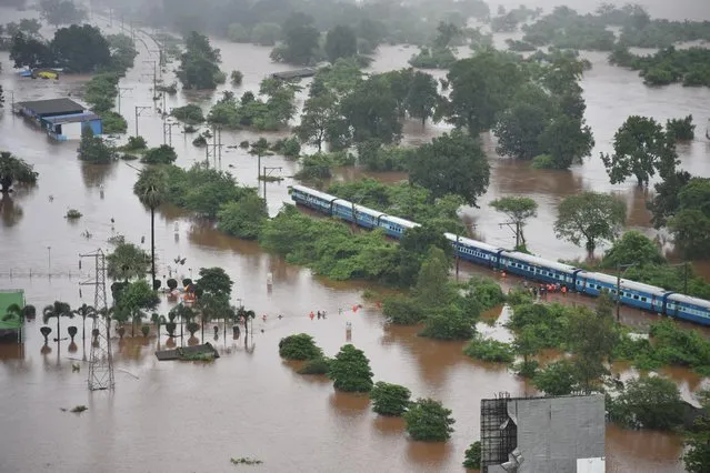 An aerial view shows a stranded passenger train in a flooded area near Badlapur, in the western state of Maharashtra, July 27, 2019. (Photo by Indian Navy/Handout via Reuters)