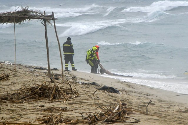 Rescuers recover a body at a beach near Cutro, southern Italy, after a migrant boat broke apart in rough seas on Sunday, February 26, 2023. Rescue officials say an undetermined number of migrants have died and dozens have been rescued after their boat broke apart off southern Italy. (Photo by Giuseppe Pipita/AP Photo)