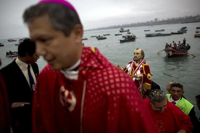 Fishermen carry the statue of Saint Peter during a procession in Lima, Peru, Monday, June 29, 2015. (Photo by Rodrigo Abd/AP Photo)