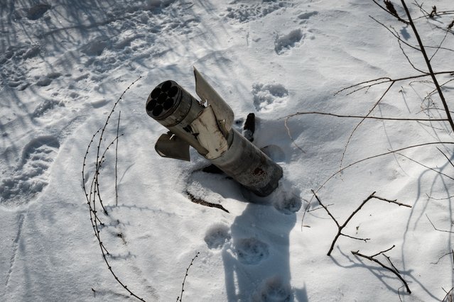 This photograph taken on February 8, 2023, shows a part of the rocket remains on the ground, covered by snow, in the frontline city of Avdiivka, amid the Russian invasion of Ukraine. (Photo by Yasuyoshi Chiba/AFP Photo)
