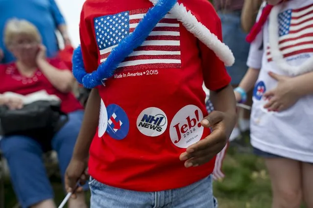 A spectator shows his collection of stickers he received during the Independence Day parade in Merrimack, New Hampshire July 4, 2015. (Photo by Gretchen Ertl/Reuters)