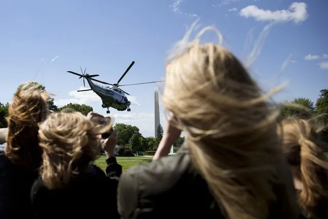Hair is blown by rotor wash from Marine One with President Barack Obama aboard, as it lifts from the South Lawn of the White House in Washington, Sunday, May 15, 2016, for the short trip to Andrews Air Force Base. Then Obama will go onto and Rutgers University's New Brunswick campus in New Jersey to speak at the Rutgers University's 250th Anniversary commencement ceremony. (Photo by Carolyn Kaster/AP Photo)