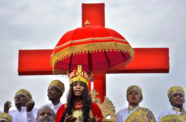 Believers chant during the Meskel celebrations, a religious holiday held by the Ethiopian Orthodox Church in Addis Ababa, Ethiopia on September 27, 2019. Meskel marks the finding by Saint Helena of the “true cross” on which Jesus was crucified. It began on September 27 afternoon with Demera, a ceremony that drew tens of thousands of people to central Addis Ababa, the capital, for hours of dancing, chanting, drumming and prayer. (Photo by Michael Tewelde/AFP Photo)