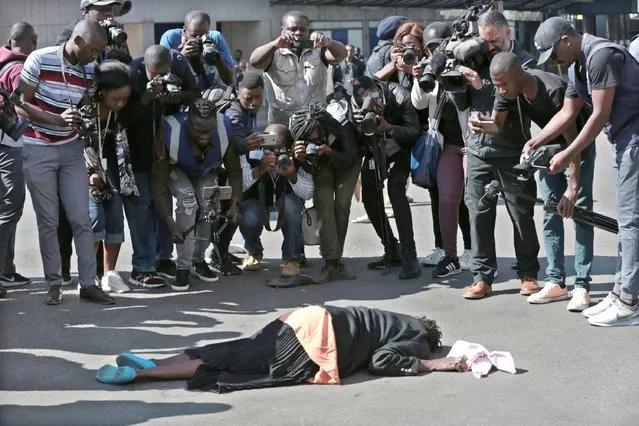 An injured protester lies on the road after clashes between Zimbabwe Republic Police (ZRP) and members of the public who took part in the Democratic Change (MDC) Alliance organised Peace March in Harare, Zimbabwe, 16 August 2019.The anti governemnt march is to protest against the cost of living, unemployment, power and fuel shortages among other issues. (Photo by Aaron Ufumeli/EPA/EFE/Rex Features/Shutterstock)