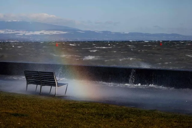 A picture taken on January 21, 2021 in Geneva shows a rainbow and waves on the lake Leman hit by strong wind. (Photo by Stefan Wermuth/AFP Photo)