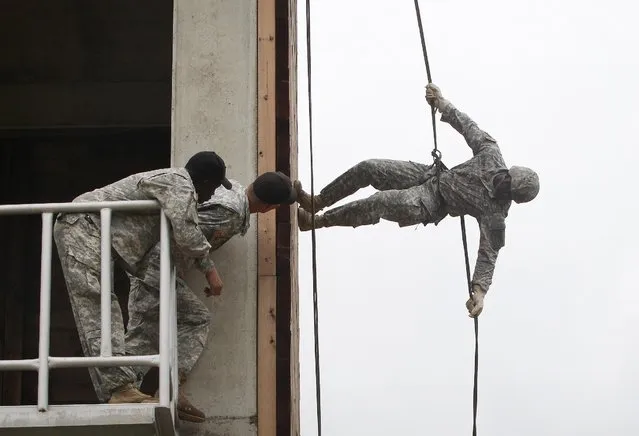 A United States Forces Korea 2nd Infantry Division soldier rappels during a training session at Camp Casey in Dongducheon, South Korea, Friday, July 24, 2015. About 200 U.S. soldiers from the 2nd Infantry Division located in South Korea took part in the 12-day course focused on combat assault operations involving U.S. Army rotary-wing aircraft. (Photo by Ahn Young-joon/AP Photo)