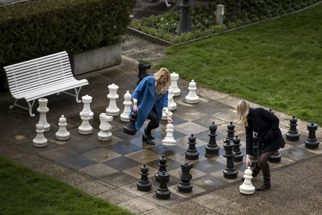 Russian journalists play a game of giant chess in a courtyard at the Beau Rivage Palace Hotel in Lausanne, April 1, 2015. (Photo by Brendan Smialowski/Reuters/Pool)