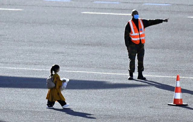 Illustration picture shows a girl going from the plane to the bus at the arrival of a chartered military airplane Airbus A330 MRTT carrying evacuated people from Afghanistan, at the military airport in Melsbroek on Wednesday, August 25, 2021. The Belgian military evacuation mission “Operation Red Kite” flies defense cargo planes back and forth between the Pakistani capital Islamabad and Kabul in Afghanistan, to get Belgians and their families, but also Afghans such as interpreters, fixers and employees of human rights organizations safely out of Afghanistan. (Photo by Rex Features/Shutterstock)