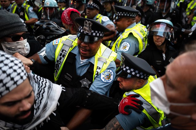 Police confront protestors as they stage a protest outside the Israeli Consulate while the Democratic National Convention (DNC) takes place at the nearby United Center on August 20, 2024 in Chicago, Illinois. The DNC started Monday and will run through August 22. (Photo by Scott Olson/Getty Images)