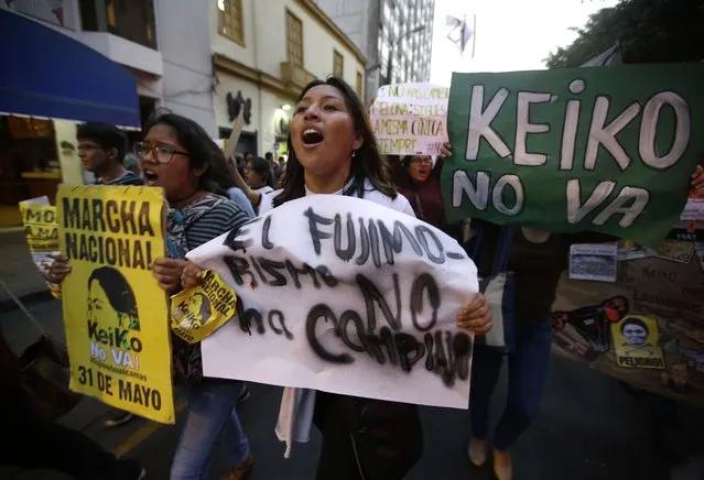 Demonstrators protest against presidential candidate Keiko Fujimori, the daughter of disgraced former leader Alberto Fujimori, at Plaza San Martin in downtown Lima, Peru, Tuesday, May 31, 2016. The South American country is gearing up for a tight June 5th runoff between Keiko Fujimori, the daughter of jailed former President Alberto Fujimori, and former World Bank economist Pedro Pablo Kuczynski. (Photo by Martin Mejia/AP Photo)