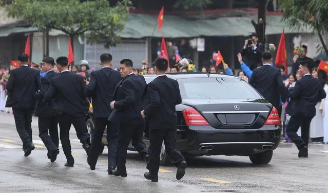 North Korean bodyguards run along a limousine transporting Kim Jong Un upon his arrival in Dong Dang, Vietnam, February 26, 2019. The second meeting of the US President and the North Korean leader, running from 27 to 28 February 2019, focuses on furthering steps towards achieving peace and complete denuclearization of the Korean peninsula. (Photo by Reuters/Stringer)