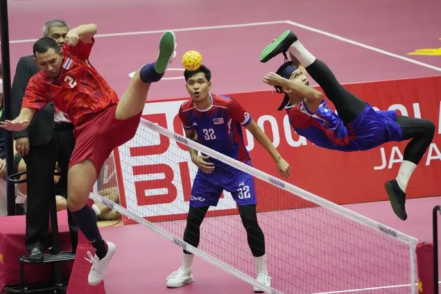 Muhammad Noaraizat Mohd Nordin of Malaysia ,right, kick a ball against  Siriwat Sakha of Thailand , left, during final men's regu sepak takraw match between Thailand  and Malaysia at the 31st Southeast Asian Games (SEA Games 31) in Hanoi , Vietnam  Tuesday, May 17, 2022. (Photo by Achmad Ibrahim/AP Photo)