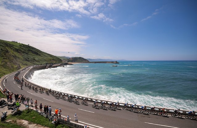 The pack of riders cycles along the Bay of Biscay coastline, near Getaria, in the Basque region of Northern Spain, during the 3rd stage of the 110th edition of the Tour de France cycling race, 193,5 km between Amorebieta-Etxano in Northern Spain and Bayonne in southwestern France, on July 3, 2023. (Photo by Thomas Samson/AFP Photo)