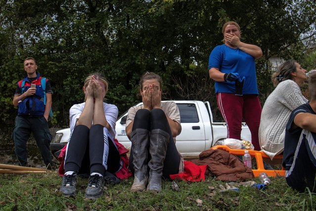 Lamija Kezo, Milhana Poturovic and Medina Kezo react after floods and landslides in a village of Trusina, Bosnia and Herzegovina, on October 6, 2024. (Photo by Marko Djurica/Reuters)