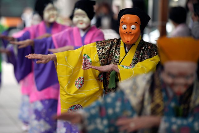 Artists wearing traditional clown masks prepare to march during the annual Shinto festival called the Grand Festival at the Kotohiragu shrine in the Toranomon business district of Tokyo, Thursday, October 10, 2024. (Photo by Eugene Hoshiko/AP Photo)