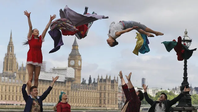 Circus artists perform a stunt opposite the Houses of Parliament to announce the official launch of Circus250 in London, Tuesday, July 25, 2017. (Photo by Frank Augstein/AP Photo)