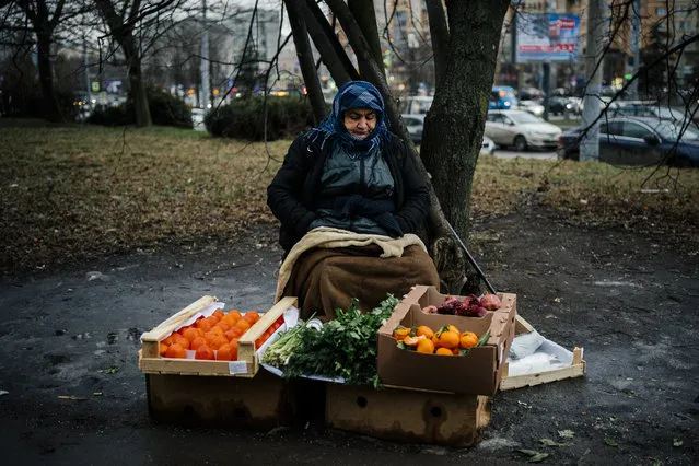 A woman sells tangerines, pomegranates, persimmons in Moscow, Russia on January 20, 2020. (Photo by Dimitar Dilkoff/AFP Photo)