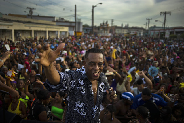 In this July 27, 2015 photo, Cuban singer Candido Fabre sings at a carnival concert in Santiago, Cuba. Santiago's promoters lament that tourists are missing out on the city's rich Afro-Cuban culture, its meandering streets, colonial architecture and its prized role as the home of Cuban musical genres such as trova and son. (Photo by Ramon Espinosa/AP Photo)