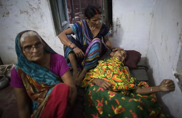 Munna Kuvar, 105, lies on a bed as she is comforted by relatives at Mukti Bhavan (Salvation House) in Varanasi, in the northern Indian state of Uttar Pradesh, June 17, 2014. (Photo by Danish Siddiqui/Reuters)