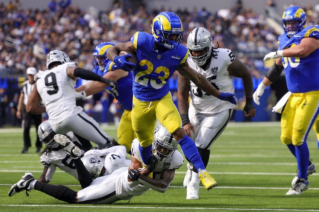 Los Angeles Rams running back Kyren Williams (23) runs for a touchdown as Las Vegas Raiders safety Isaiah Pola-Mao, bottom, attempts to tackle during the first half of an NFL football game against the Las Vegas Raiders, Sunday, October 20, 2024, in Inglewood, Calif. (Photo by Ryan Sun/AP Photo)