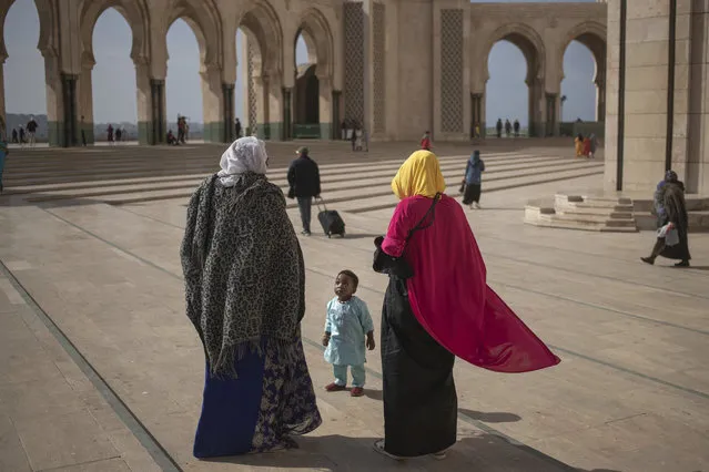 A Muslim family walks after performing Friday prayers outside the mosque of Hassan II, one of the largest in Africa, in Casablanca, Morocco, Friday, February 7, 2020. (Photo by Mosa'ab Elshamy/AP Photo)