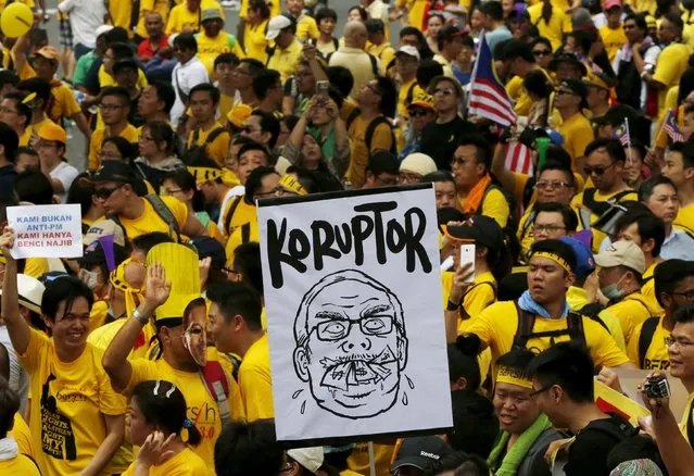 Protesters march at a rally organised by pro-democracy group “Bersih” (Clean) in Malaysia's capital city of Kuala Lumpur, August 29, 2015. The placards read, “Corruptor” and “We are not against prime minister, we just hate Najib” (L). (Photo by Olivia Harris/Reuters)