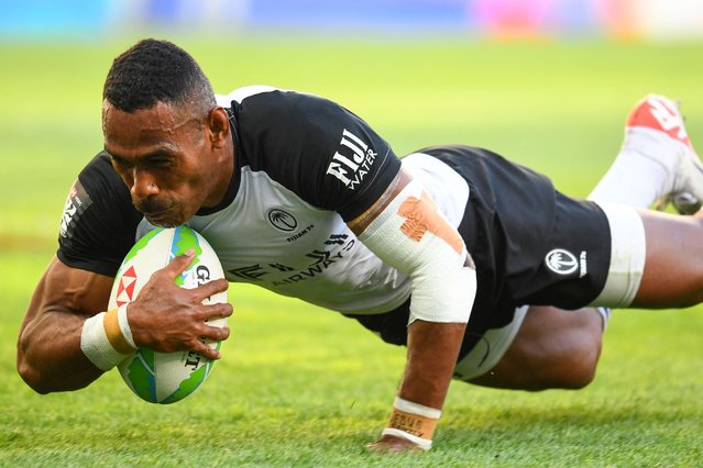 Fiji's Kavekini Tanivanuakula scores a try during the third place play-off of the HSBC World Rugby Sevens Series men's rugby match between Spain and Fiji at the Cape Town stadium in Cape Town on December 8, 2024. (Photo by Rodger Bosch/AFP Photo)