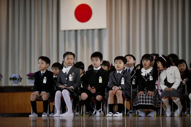Children attend a ceremony on their first day of school at Shimizu elementary school in Fukushima, northern Japan April 6, 2011. Over 70 schools began their regular classes on Wednesday in the city of Fukushima, after the earthquake and tsunami that hit the country on March 11. (Photo by Carlos Barria/Reuters)