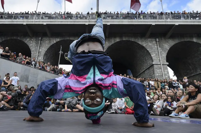 A competitor performs during a street dance battle at the 3rd edition of the Red Bull Beat It!, in Lausanne, Switzerland, August 23, 2014. (Photo by Laurent Gillieron/EPA)