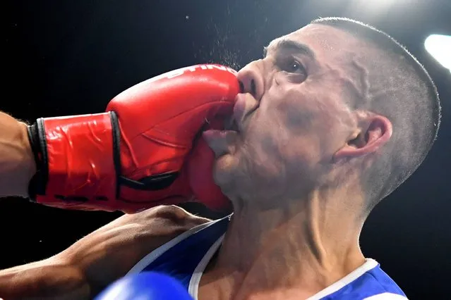 France's Sofiane Oumiha (L) lands a punch on Honduras' Teofimo Andres Lopez Rivera during the Men's Light (60kg) match at the Rio 2016 Olympic Games at the Riocentro – Pavilion 6 in Rio de Janeiro on August 7, 2016. (Photo byYuri Cortez /AFP Photo)