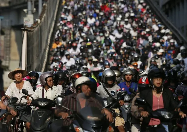 In this September 4, 2014, photo, thousands of motor scooters wait at a stoplight during the morning commute in Taipei, Taiwan. There are 15.09 million motorcycles in Taiwan, or 67.6 for every 100 people according to statistics from Taiwan's 2013 official Directorate General of Budget, Accounting and Statistics (DGBAS). (Photo by Wally Santana/AP Photo)