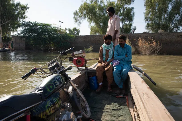 People take boats to cross floodwaters to reach Johi on October 18, 2022 in Dadu, Pakistan. Nearly one-third of Pakistan was deeply affected by flooding which hit the country in 2022, with many areas still inundated or recovering from the event which left millions of people dispossessed of land and lacking food, water or work. (Photo by Getty Images)