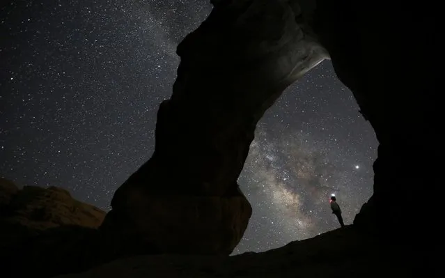 A man watches the stars seen on the sky of Al-Kharza area of Wadi Rum in the south of Amman, Jordan, July 27, 2019. (Photo by Muhammad Hamed/Reuters)