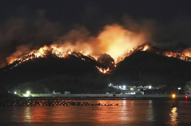 A forest fire, which started last Wednesday, continues to spread behind houses in Ofunato, Iwate prefecture, northern Japan, Monday, March 3, 2025. (Photo by Kyodo News via AP Photo)