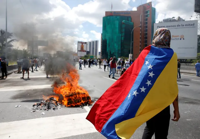 Protesters clash with riot police during a rally to demand a referendum to remove Venezuela's President Nicolas Maduro in Caracas, Venezuela, September 1, 2016. (Photo by Carlos Garcia Rawlins/Reuters)