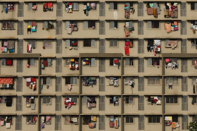 Washing hangs from the windows of a residential building in Mumbai, India on November 27, 2017. (Photo by Danish Siddiqui/Reuters)
