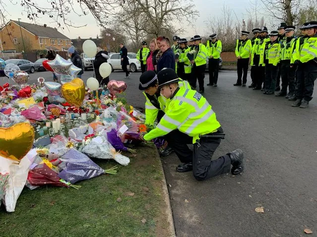 21 Officers from West Midlands Police lay bouquets of flowers and stood in silence near to the scene in Babbs Mill Park in Kingshurst, Solihull on Tuesday, December 13, 2022, after the deaths of three boys aged eight, 10 and 11 who fell through ice into a lake in the West Midlands. (Photo by Richard Vernalls/PA Images via Getty Images)