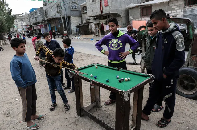 Palestinian boys play pool in the Rafah refugee camp in the southern Gaza Strip on January 4, 2018. (Photo by Said Khatib/AFP Photo)