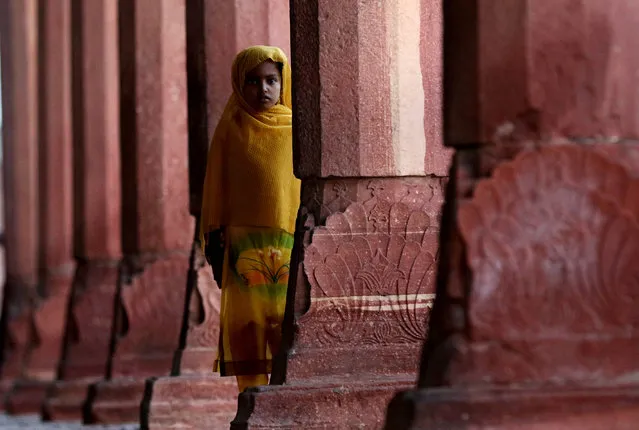 A young girl stands between the pillars of Diwan-e-Aam, in the Lahore Fort, Lahore, Pakistan, September 29, 2015.  The fort, which was made a UNESCO world heritage site in 1981, was built by the Mughal King Akbar in the 1560s and still towers over the old city of Lahore.  (Photo by Rhat Dar/EPA)