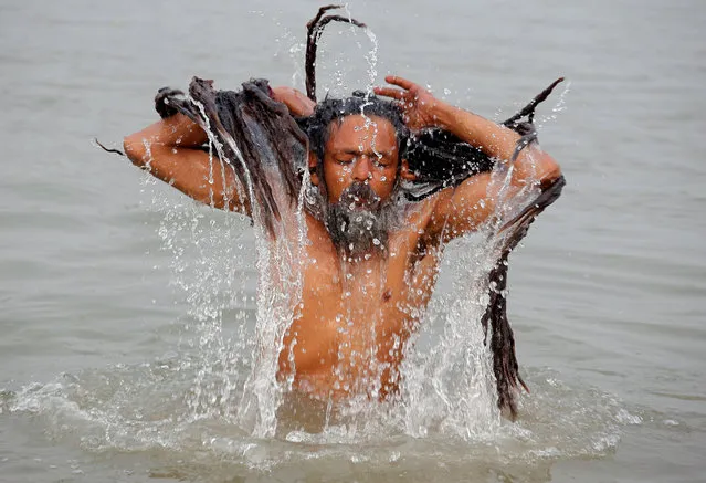 A Sadhu or a Hindu holy man takes a dip in the waters of the river Ganges on the occasion of “Makar Sankranti” festival in Kolkata, January 14, 2018. (Photo by Rupak De Chowdhuri/Reuters)