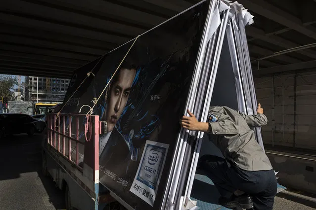 A truck driver gets a load of signs advertising Intel microchips ready for delivery on May 24, 2016. The tech business has boomed in Beijing. (Photo by Michael Robinson Chavez/The Washington Post)